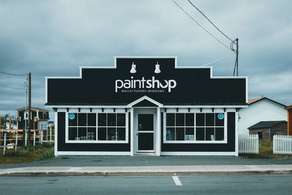 Street view of a quaint paint shop with distinctive facade and classic signage.