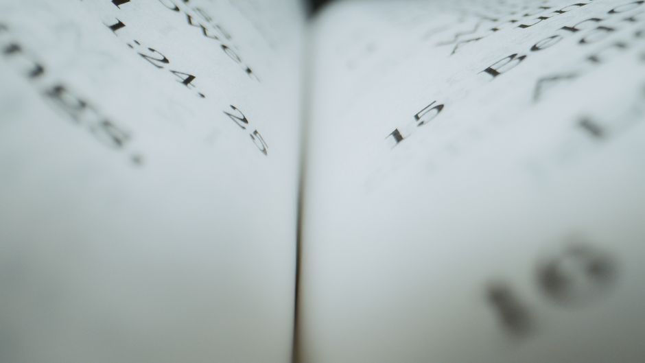 Detailed close-up of text on book pages, ideal for reading or literary themes.